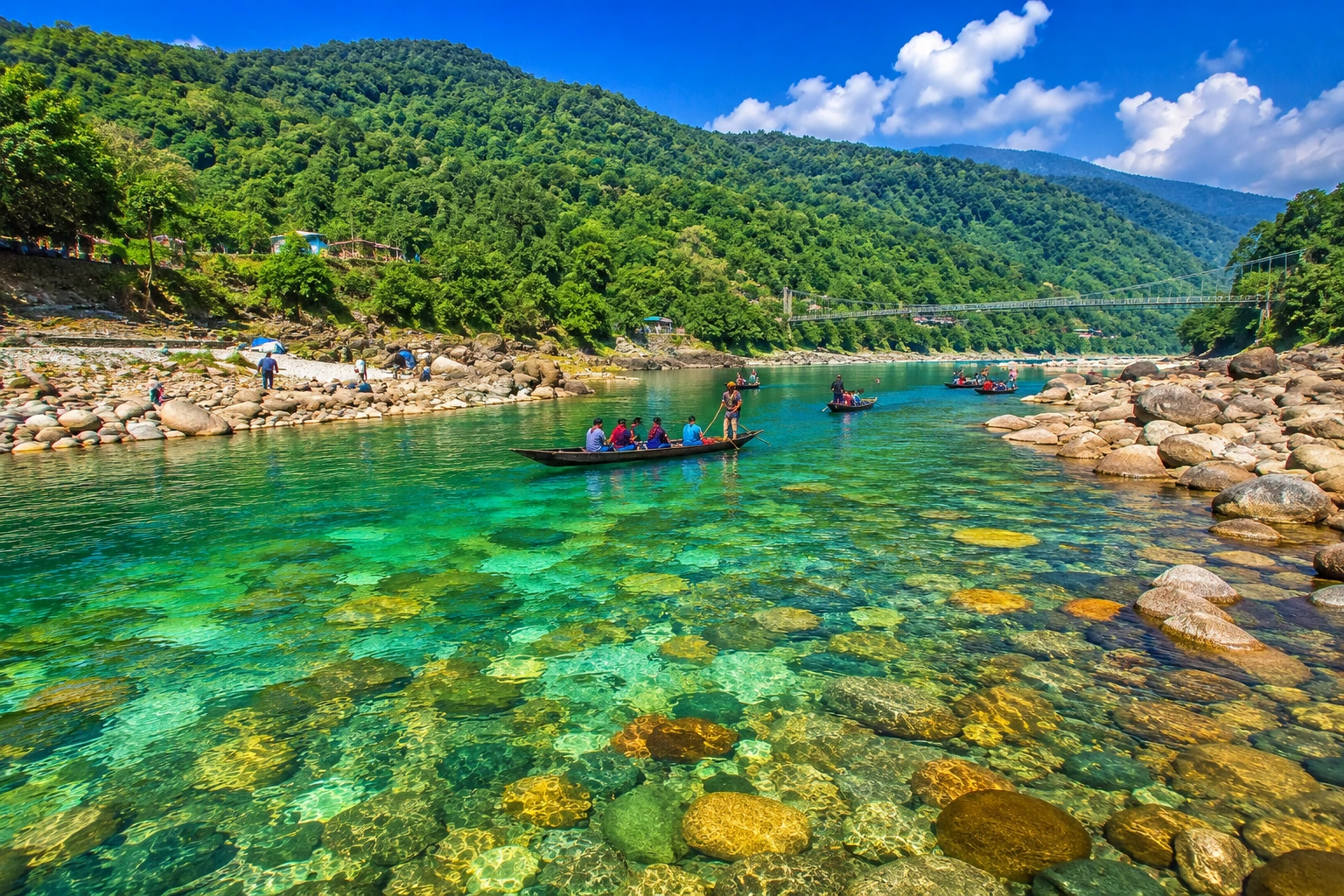 A clear river flowing between green hills