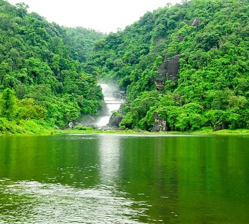 A waterfall surrounded by green hills
